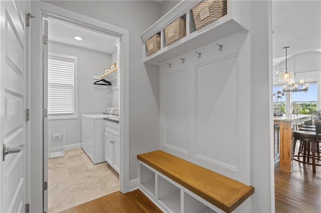 4313 Lakeview Ter, Basehor, KS 66007 - mudroom featuring washer and clothes dryer, baseboards, a chandelier, and light marble finish floors