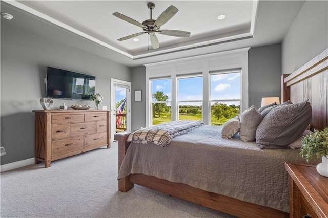 4313 Lakeview Ter, Basehor, KS 66007 - bedroom featuring a tray ceiling, light colored carpet, a ceiling fan, access to outside, and baseboards