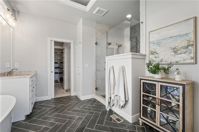 4313 Lakeview Ter, Basehor, KS 66007 - full bathroom featuring a shower stall, vanity, a spacious closet, a freestanding bath, and baseboards