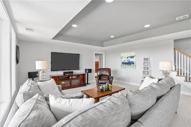 4313 Lakeview Ter, Basehor, KS 66007 - living area with light colored carpet, stairway, recessed lighting, baseboards, and a tray ceiling