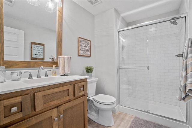 4313 Lakeview Ter, Basehor, KS 66007 - full bath featuring toilet, a stall shower, vanity, and wood finished floors