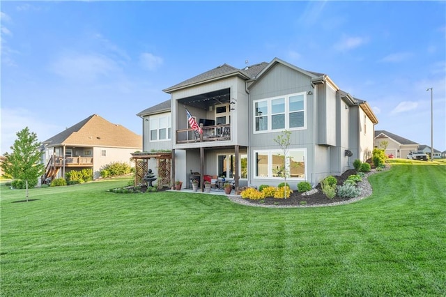 4313 Lakeview Ter, Basehor, KS 66007 - back of house featuring a balcony, a lawn, and a patio area