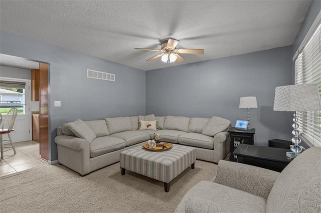 105 SW Alderson Pl, Lees Summit, MO 64063 - living area featuring ceiling fan, light colored carpet, and a textured ceiling