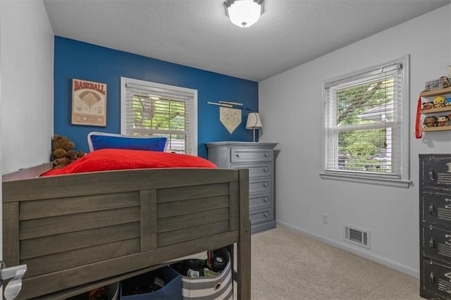 105 SW Alderson Pl, Lees Summit, MO 64063 - bedroom featuring multiple windows, carpet, a textured ceiling, and baseboards