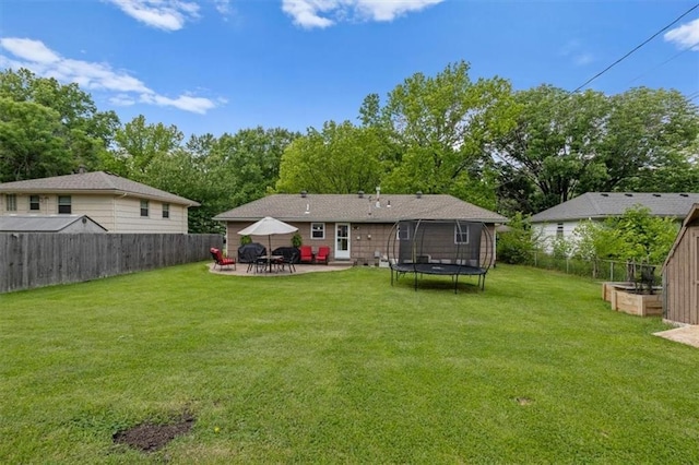 105 SW Alderson Pl, Lees Summit, MO 64063 - back of house with a patio, a trampoline, and view of wooded area