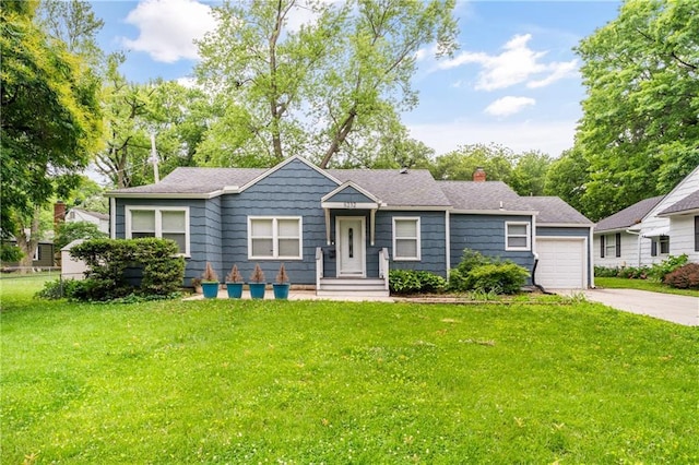 5232 Alder Dr, Roeland Park, KS 66205 - view of front of house with driveway, a front yard, a chimney, and a garage