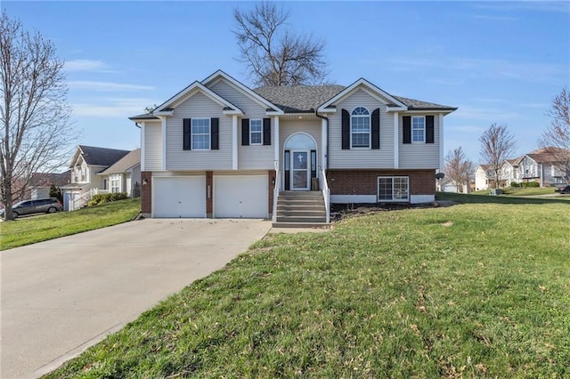 3708 N 112th St, Kansas City, KS 66109 - bi-level home with brick siding, concrete driveway, a garage, and a front yard