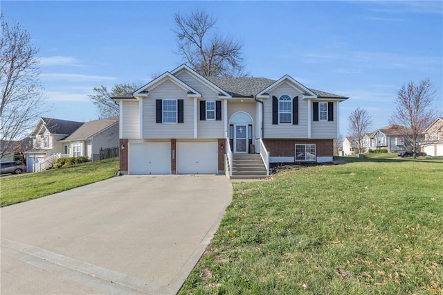 3708 N 112th St, Kansas City, KS 66109 - split foyer home with brick siding, concrete driveway, an attached garage, a front lawn, and a residential view