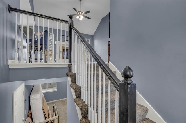 3708 N 112th St, Kansas City, KS 66109 - stairway with ceiling fan, baseboards, carpet, and lofted ceiling