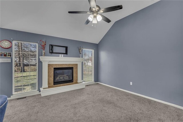3708 N 112th St, Kansas City, KS 66109 - unfurnished living room featuring ceiling fan, carpet flooring, a tiled fireplace, lofted ceiling, and baseboards