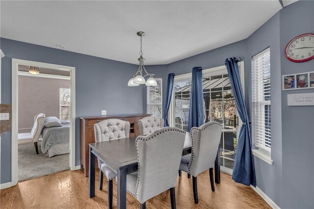 3708 N 112th St, Kansas City, KS 66109 - dining space featuring plenty of natural light, light wood-style floors, baseboards, and a chandelier