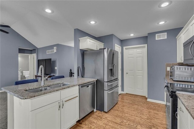 3708 N 112th St, Kansas City, KS 66109 - kitchen featuring appliances with stainless steel finishes, a sink, a peninsula, white cabinets, and light wood finished floors