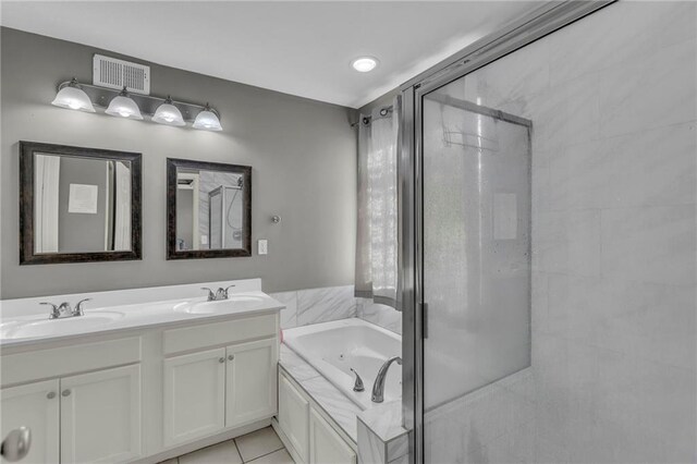 3708 N 112th St, Kansas City, KS 66109 - bathroom featuring a shower stall, double vanity, a jetted tub, and tile patterned flooring