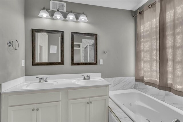 3708 N 112th St, Kansas City, KS 66109 - bathroom featuring double vanity and a jetted tub