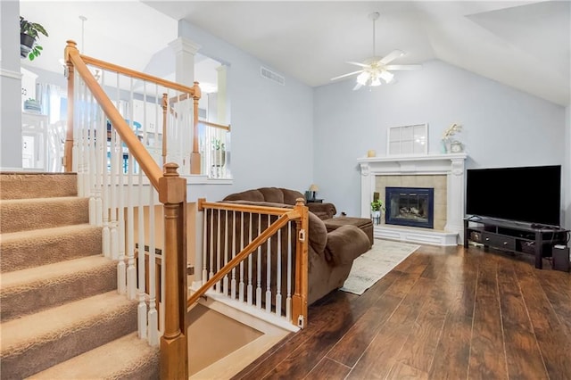 616 N Winwood Ter, Gardner, KS 66030 - living room with hardwood / wood-style floors, a ceiling fan, stairs, a tile fireplace, and vaulted ceiling