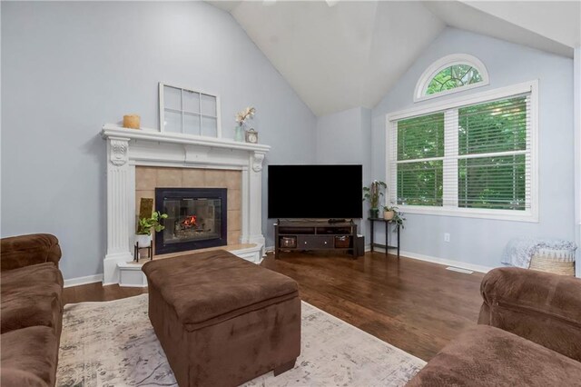 616 N Winwood Ter, Gardner, KS 66030 - living area featuring a tile fireplace, vaulted ceiling, wood finished floors, and baseboards