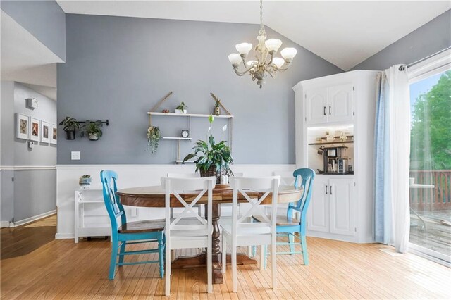 616 N Winwood Ter, Gardner, KS 66030 - dining space with a chandelier, light wood-style flooring, and vaulted ceiling