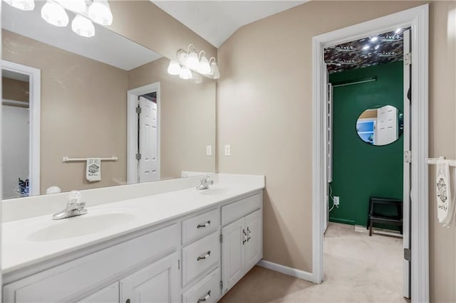 616 N Winwood Ter, Gardner, KS 66030 - bathroom with double vanity, baseboards, and vaulted ceiling