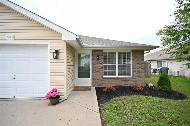 603 Terry Dr, Pleasant Hill, MO 64080 - property entrance featuring brick siding, a garage, and a shingled roof