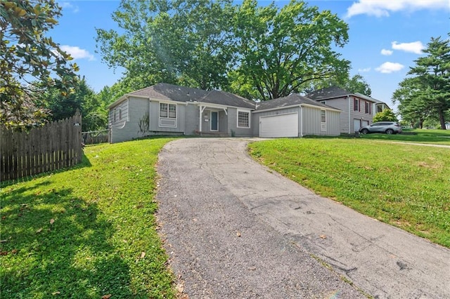 10538 Cleveland Ave, Kansas City, MO 64137 - view of front of home featuring asphalt driveway and an attached garage