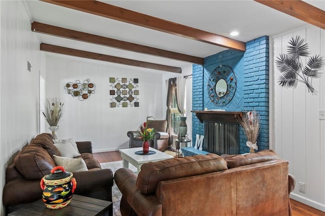 10538 Cleveland Ave, Kansas City, MO 64137 - living room with wood finished floors, beam ceiling, and a brick fireplace