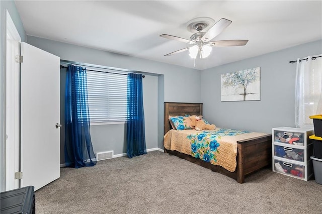 10538 Cleveland Ave, Kansas City, MO 64137 - carpeted bedroom featuring multiple windows and a ceiling fan