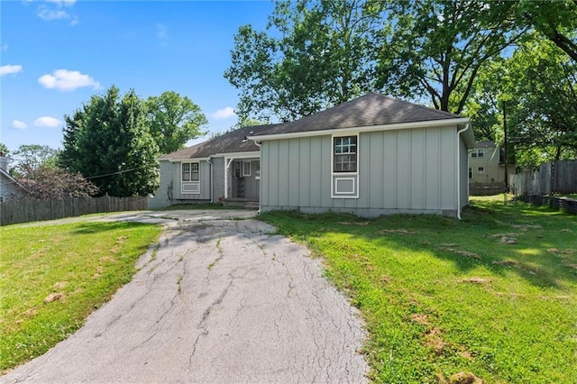 10538 Cleveland Ave, Kansas City, MO 64137 - ranch-style house with board and batten siding and asphalt driveway