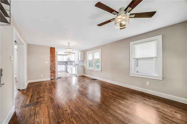 1025 S Park Ave, Independence, MO 64050 - unfurnished living room featuring wood finished floors and ceiling fan