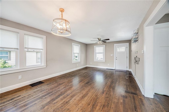 1025 S Park Ave, Independence, MO 64050 - unfurnished living room with dark wood-type flooring, ceiling fan, and a chandelier