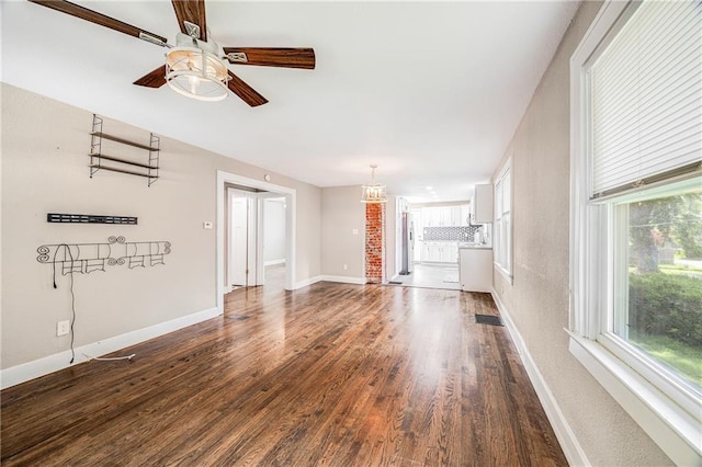 1025 S Park Ave, Independence, MO 64050 - unfurnished living room featuring a ceiling fan and dark wood finished floors