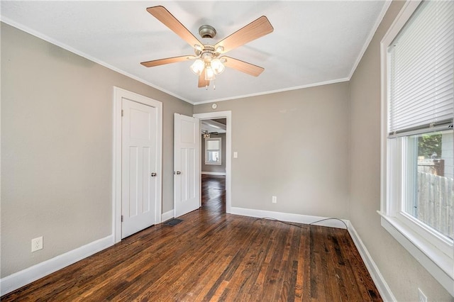 1025 S Park Ave, Independence, MO 64050 - unfurnished room featuring healthy amount of natural light, wood finished floors, ornamental molding, and a ceiling fan