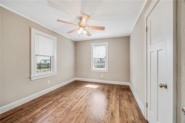 1025 S Park Ave, Independence, MO 64050 - spare room featuring crown molding, wood finished floors, and ceiling fan