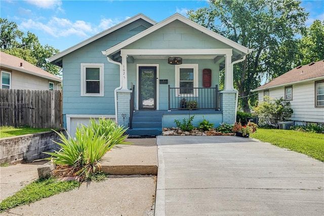 1025 S Park Ave, Independence, MO 64050 - view of front of house with covered porch and an attached garage