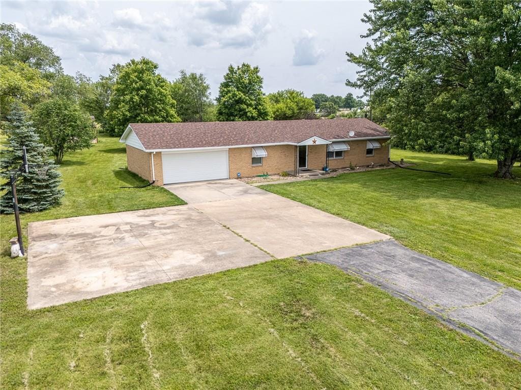 32581 Lookout Rd, Paola, KS 66071 - single story home featuring brick siding, concrete driveway, a front lawn, and a garage