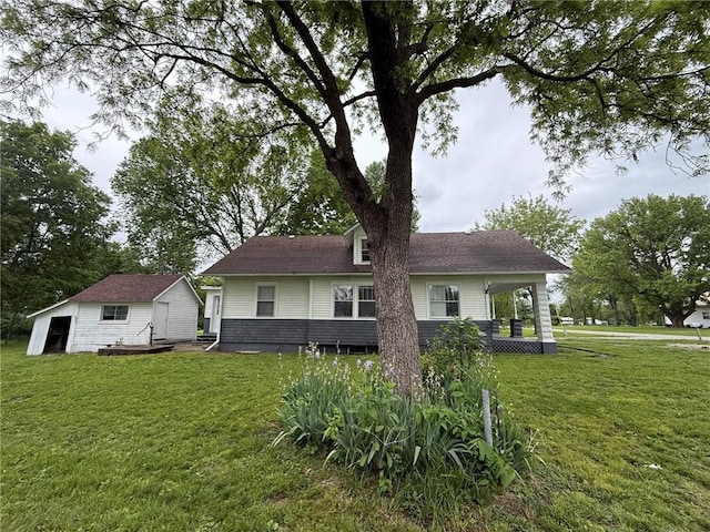 347 Walnut St, Kidder, MO 64649 - back of house featuring an outbuilding and a lawn