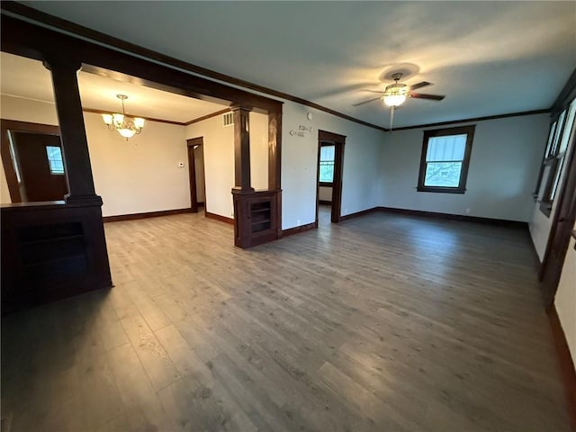 347 Walnut St, Kidder, MO 64649 - unfurnished living room with ornate columns, crown molding, baseboards, a chandelier, and wood finished floors