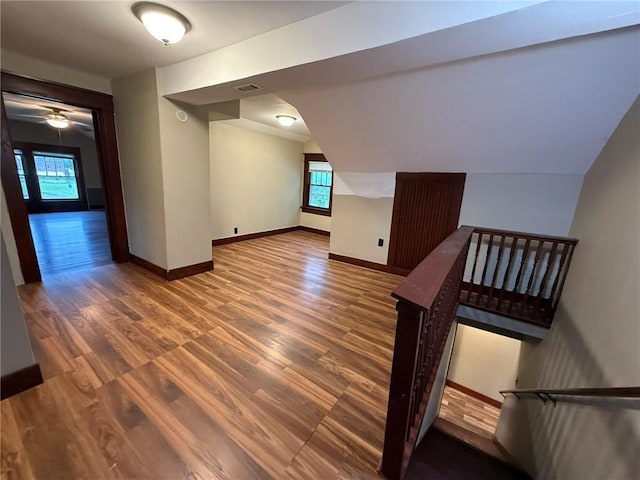 347 Walnut St, Kidder, MO 64649 - unfurnished living room featuring wood finished floors, baseboards, a ceiling fan, and lofted ceiling