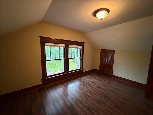 347 Walnut St, Kidder, MO 64649 - bonus room featuring lofted ceiling, dark wood-type flooring, and baseboards