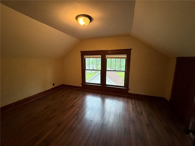 347 Walnut St, Kidder, MO 64649 - bonus room featuring dark wood-style flooring, vaulted ceiling, and baseboards
