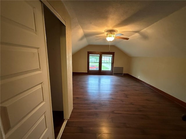 347 Walnut St, Kidder, MO 64649 - bonus room featuring ceiling fan, lofted ceiling, dark wood-type flooring, baseboards, and a textured ceiling