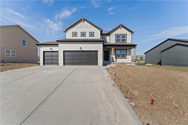 18232 W 166th St, Olathe, KS 66062 - view of front of house featuring concrete driveway, a porch, board and batten siding, and a garage