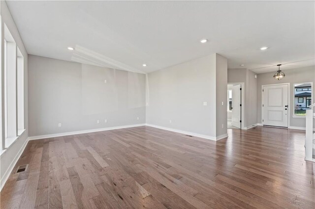 18232 W 166th St, Olathe, KS 66062 - unfurnished living room with wood finished floors, baseboards, and recessed lighting