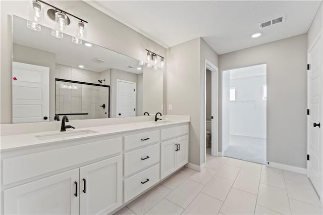 18232 W 166th St, Olathe, KS 66062 - full bathroom with a shower stall, double vanity, toilet, baseboards, and a closet