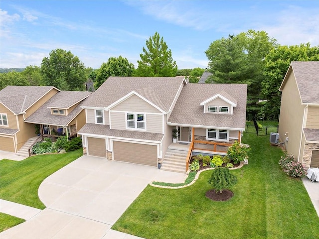 21419 W 47th Ter, Shawnee, KS 66218 - craftsman-style home with a garage, concrete driveway, stairway, a shingled roof, and central AC