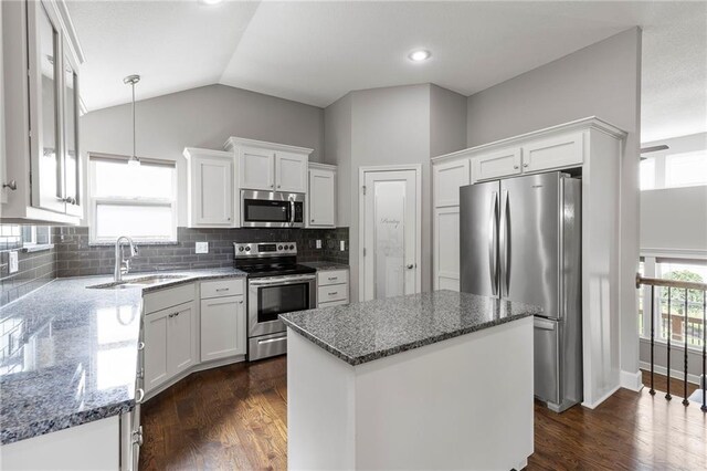 21419 W 47th Ter, Shawnee, KS 66218 - kitchen with stainless steel appliances, a sink, dark stone countertops, white cabinets, and lofted ceiling