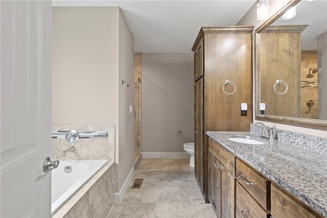 21419 W 47th Ter, Shawnee, KS 66218 - full bath featuring vanity, toilet, a bath, baseboards, and a tile shower
