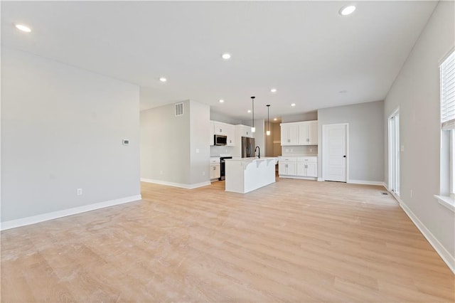 18257 W 166th St, Olathe, KS 66062 - unfurnished living room featuring light wood-style floors and recessed lighting