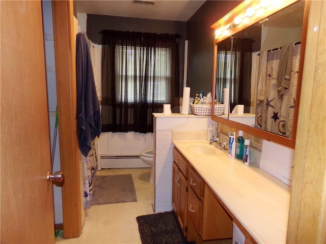 4426 Shrine Park Rd, Leavenworth, KS 66048 - full bath with baseboard heating, toilet, and vanity