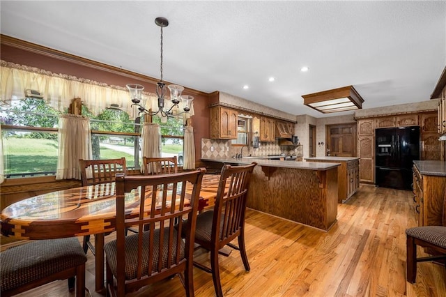 19819 Mclouth Rd, Tonganoxie, KS 66086 - dining room featuring a chandelier, light wood-style flooring, recessed lighting, and crown molding