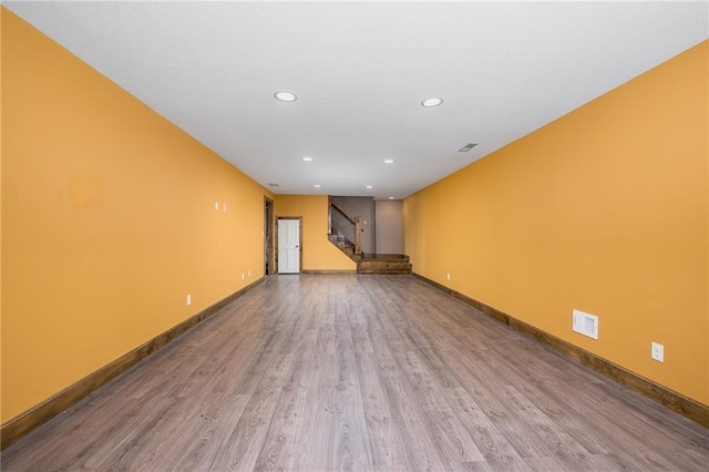 19819 Mclouth Rd, Tonganoxie, KS 66086 - empty room with wood finished floors, stairway, recessed lighting, and baseboards